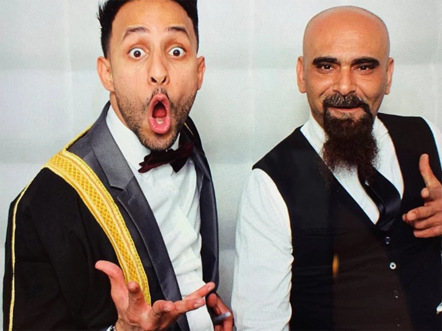 Two men in formal attire posing for 360 camera booth rental in East Downtown, one with a surprised expression
