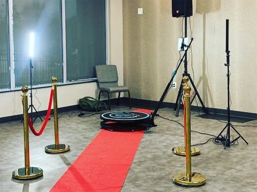 Luxurious 360 Photo Booth Rentals in Central Business District with a red carpet and gold stanchions