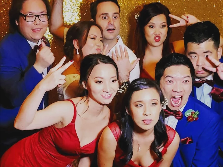 Group enjoying Affordable Rotating Photo Booth Rentals in Central Business District with fun poses
