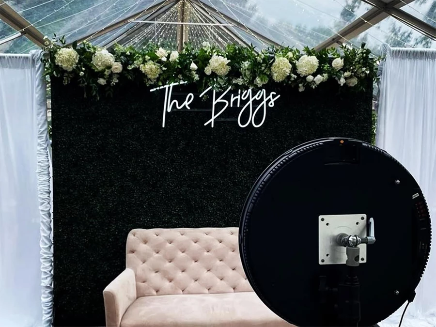 Elegant setup featuring Central Business District’s Best Rotating Photo Booth Experience with floral decor