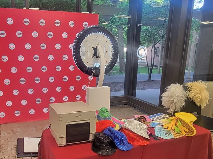 Event setup featuring Event photo booth in Central Business District with festive hats and printer