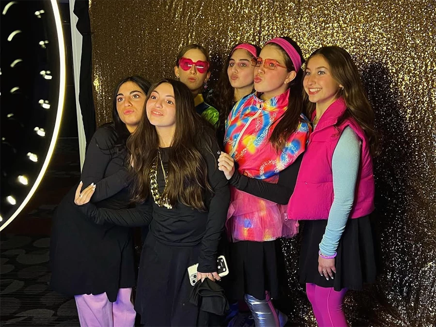 Group of friends posing at Photo booth hire for parties in Central Business Distric with gold glitter backdrop