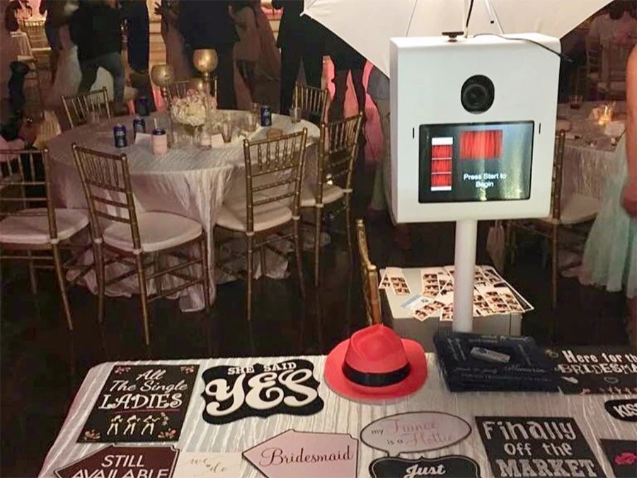 Unique Spin Camera Rentals for Events in East Downtown at a wedding with a photo booth and festive props